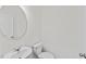 Clean powder room featuring a modern round mirror and commode at 129 Gladstone Loop, Clayton, NC 27520