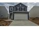 Charming two-story home with a two car garage and neutral gray siding and a concrete driveway at 131 N Keatts Winner Ct, Wilson's Mills, NC 27520