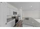 This kitchen has white cabinets, stainless steel appliances, and granite countertops at 131 N Keatts Winner Ct, Wilson's Mills, NC 27520