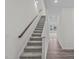 A carpeted staircase with wood handrail leads to the upper level of the home at 131 N Keatts Winner Ct, Wilson's Mills, NC 27520