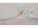 Bright, carpeted room with ample natural light from sliding glass door, offering a cozy and inviting atmosphere at 133 Gladstone Loop, Clayton, NC 27520