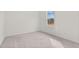 A well-lit bedroom features neutral walls, plush carpeting and a bright window at 133 Gladstone Loop, Clayton, NC 27520