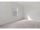 Cozy bedroom with a sunlit window and neutral carpet at 133 Gladstone Loop, Clayton, NC 27520