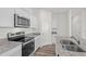 Bright kitchen featuring granite countertops, stainless steel appliances, white cabinets, and modern fixtures at 133 Gladstone Loop, Clayton, NC 27520