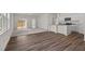 Open-concept living space featuring hardwood flooring and connecting seamlessly to the kitchen with modern appliances at 133 Gladstone Loop, Clayton, NC 27520