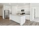 Bright kitchen features stainless steel appliances, granite countertops, and an island with a sink at 137 Gladstone Loop, Clayton, NC 27520