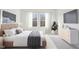 A staged bedroom features neutral tones, soft textures, natural light, and curated decor for a tranquil retreat at 137 Gladstone Loop, Clayton, NC 27520