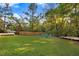 Large backyard with lush green grass, trees, and outdoor seating areas at 1518 Echo Rd, Durham, NC 27707