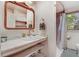 Bathroom featuring bright, clean sink and mirror with shower and toilet in the background at 1518 Echo Rd, Durham, NC 27707
