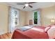 Bedroom featuring wood floors, two windows and neutral tones at 1518 Echo Rd, Durham, NC 27707