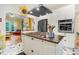 Bright kitchen with stainless appliances, cooktop island, and an open view to a charming living space at 1518 Echo Rd, Durham, NC 27707