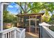 Screened-in patio with deck and comfortable seating area at 1518 Echo Rd, Durham, NC 27707