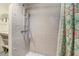 Shower with modern tile and fixtures, next to built-in shelving at 1518 Echo Rd, Durham, NC 27707