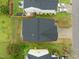 Aerial view showing a well-maintained home with lush green grass, a dark roof, and a clean driveway and sidewalk at 1533 Brown Owl Dr, Raleigh, NC 27610
