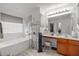 Bright bathroom with a large tub, vanity, and decorative accents at 1533 Brown Owl Dr, Raleigh, NC 27610