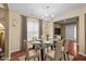 Bright dining room with a glass table, six chairs, and decorative chandelier at 1533 Brown Owl Dr, Raleigh, NC 27610