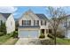 Charming two-story home with a two-car garage, mature trees, and well-maintained landscaping at 1533 Brown Owl Dr, Raleigh, NC 27610