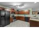 Kitchen with dark wood cabinets, stainless steel appliances, and ample counter space at 1533 Brown Owl Dr, Raleigh, NC 27610