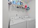 Laundry room with white washer and dryer and shelving above at 1533 Brown Owl Dr, Raleigh, NC 27610