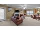 Comfortable living room with a fireplace, leather seating, and a large window at 1533 Brown Owl Dr, Raleigh, NC 27610