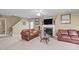 Inviting living room features a fireplace, neutral walls, and cozy leather sofas at 1533 Brown Owl Dr, Raleigh, NC 27610