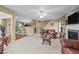Spacious living room featuring a ceiling fan, leather sofas, and staircase at 1533 Brown Owl Dr, Raleigh, NC 27610