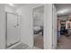 This is a view of the bedroom with an attached bathroom featuring a glass enclosed shower and an attached walk-in closet at 1533 Brown Owl Dr, Raleigh, NC 27610