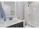Bright bathroom featuring a tiled shower-tub, stylish vanity, and neutral decor at 1601 Bowery Dr, Raleigh, NC 27607