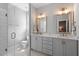 Modern bathroom featuring a double vanity, sleek mirrors, and a glass-enclosed shower at 1601 Bowery Dr, Raleigh, NC 27607