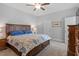 Bright bedroom showcasing a bed with decorative pillows, neutral paint, and an ensuite bathroom at 1601 Bowery Dr, Raleigh, NC 27607