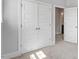 Bedroom interior showcasing large closet with paneled doors and access to bathroom at 1601 Bowery Dr, Raleigh, NC 27607