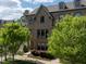 Beautiful brick townhome featuring manicured landscaping, lush trees, and inviting front entrance at 1601 Bowery Dr, Raleigh, NC 27607