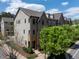 Street view of a brick townhome with stone accents, landscaped front yard and street trees at 1601 Bowery Dr, Raleigh, NC 27607
