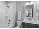 Bright bathroom with white subway tiles, bronze fixtures, and a vanity with ample storage space at 1601 Bowery Dr, Raleigh, NC 27607