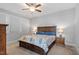 Spacious bedroom with ceiling fan, plush carpet, and large bed with decorative bedding at 1601 Bowery Dr, Raleigh, NC 27607