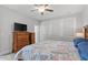 Bedroom showcasing dresser, ceiling fan, and natural light from the large windows at 1601 Bowery Dr, Raleigh, NC 27607