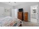 Bedroom featuring dresser, television, and access to the primary bathroom at 1601 Bowery Dr, Raleigh, NC 27607