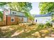 A spacious backyard features a wooden deck, with mature trees and an additional detached garage at 1617 Woodland Ave, Burlington, NC 27215