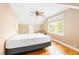 Cozy bedroom featuring hardwood floors, dormer window, and ceiling fan, offering a comfortable space at 1617 Woodland Ave, Burlington, NC 27215