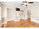 Spacious bedroom featuring hardwood floors, ceiling fan, and two closets for ample storage at 1617 Woodland Ave, Burlington, NC 27215