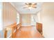Cozy bedroom with wood-look floors, natural lighting, fan and paneling throughout the room at 1617 Woodland Ave, Burlington, NC 27215