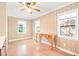 Bright bedroom with wood-look floors, ceiling fan and paneled walls, providing a comfortable retreat at 1617 Woodland Ave, Burlington, NC 27215