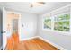 Bright bedroom featuring hardwood floors and plenty of natural light from two windows, creating a refreshing space at 1617 Woodland Ave, Burlington, NC 27215