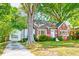 Charming brick home with lush front yard, beautiful landscaping, and a detached garage at 1617 Woodland Ave, Burlington, NC 27215