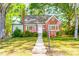 Beautiful brick home with a manicured lawn and colorful landscaping at 1617 Woodland Ave, Burlington, NC 27215