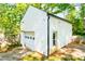 A detached garage with a traditional door and side door, offering additional storage and parking at 1617 Woodland Ave, Burlington, NC 27215