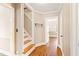 Hallway with hardwood floors and staircase, creating an open and welcoming transition between spaces at 1617 Woodland Ave, Burlington, NC 27215