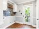 Practical laundry room featuring storage cabinets, and convenient access to the outdoors at 1617 Woodland Ave, Burlington, NC 27215