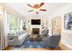 Bright living room featuring a cozy fireplace, built-in bookshelves, and a large window at 1617 Woodland Ave, Burlington, NC 27215