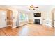 Open living room with hardwood floors, a fireplace, and ample natural light at 1617 Woodland Ave, Burlington, NC 27215